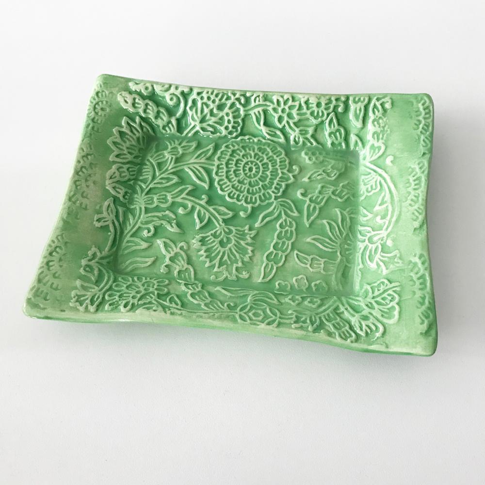 Handmade pottery tray by Lorraine Oerth in flower design.